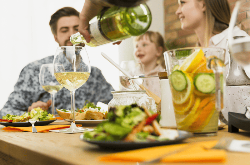 at the table, family, glass, wine Freepik Photo